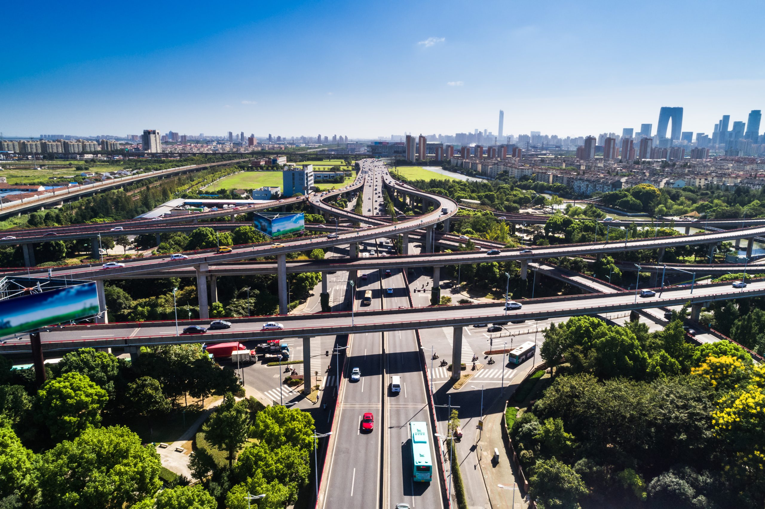Aerial view massive highway intersection, stack interchange with elevated road junction overpass at late afternoon in Houston, Texas. This five-level freeway interchange carry heavy traffic, panorama.